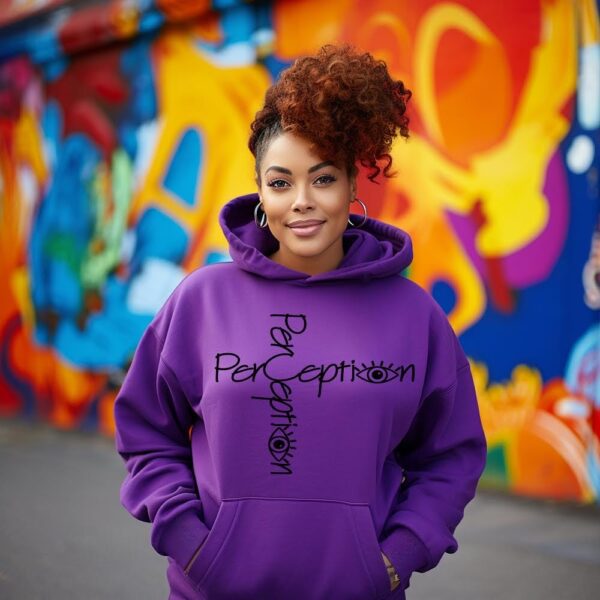 A woman standing in front of a wall with graffiti.