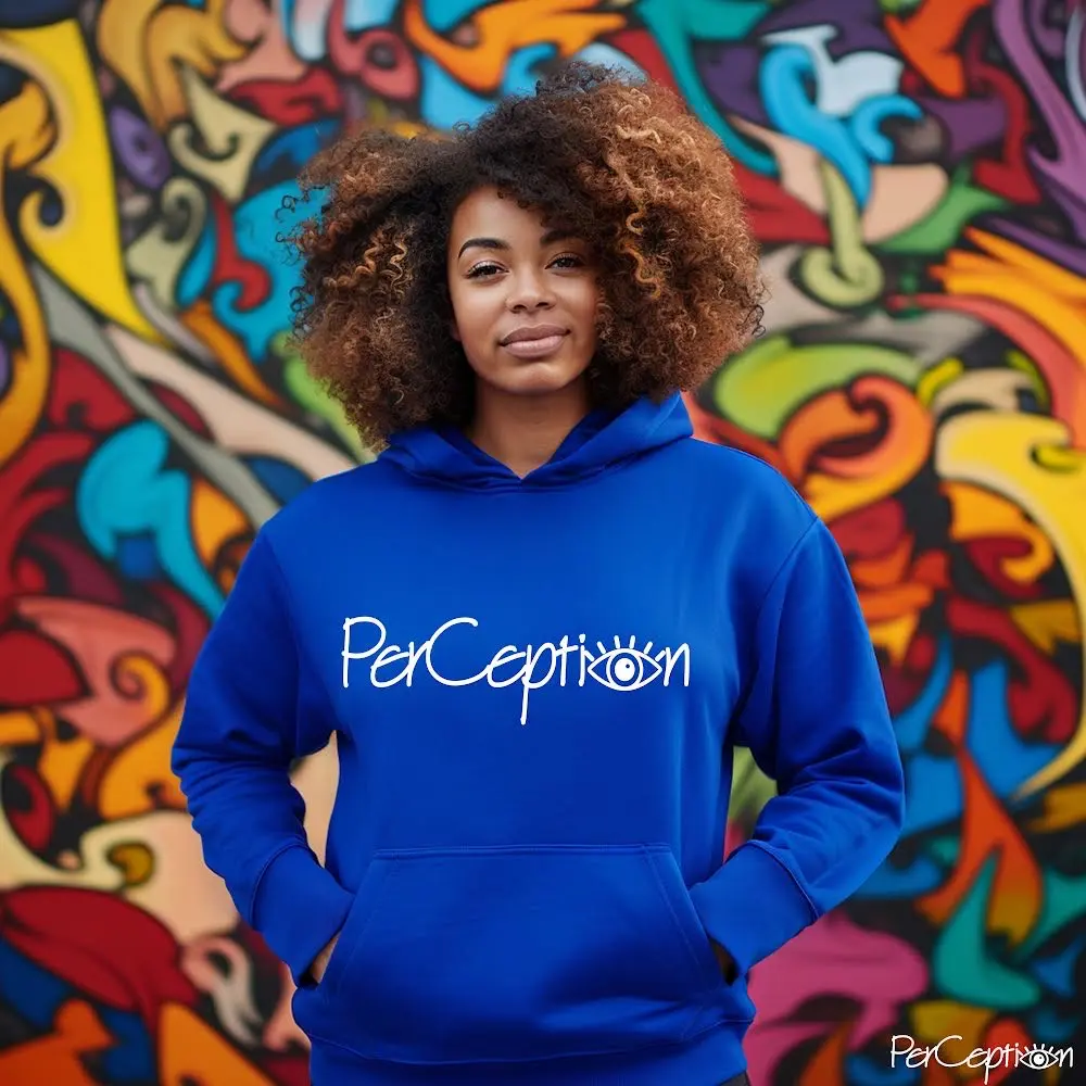 A woman standing in front of a wall with graffiti.